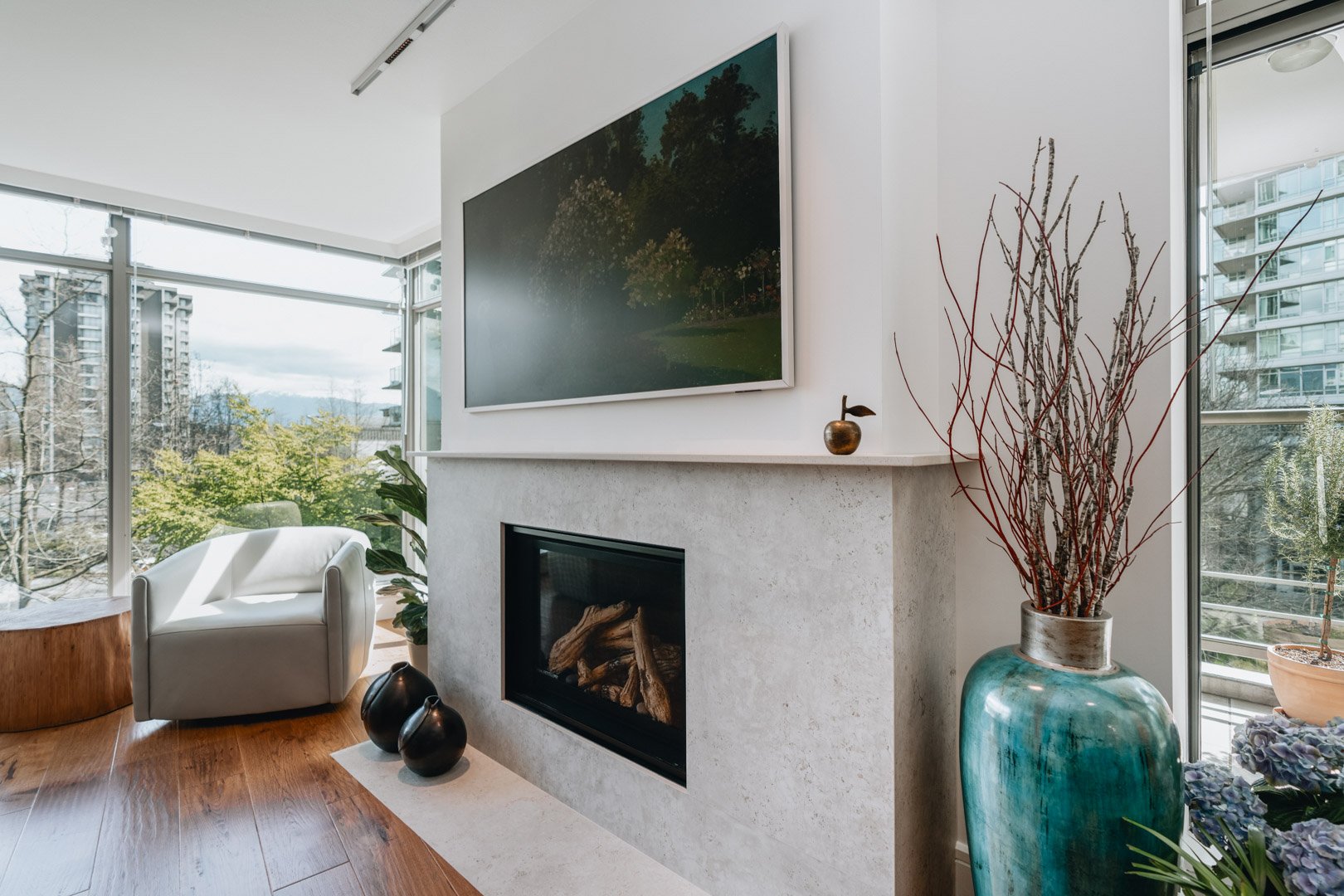 55-00-Close-up side view of a modern light gray stone fireplace mantle in a Vancouver home.
