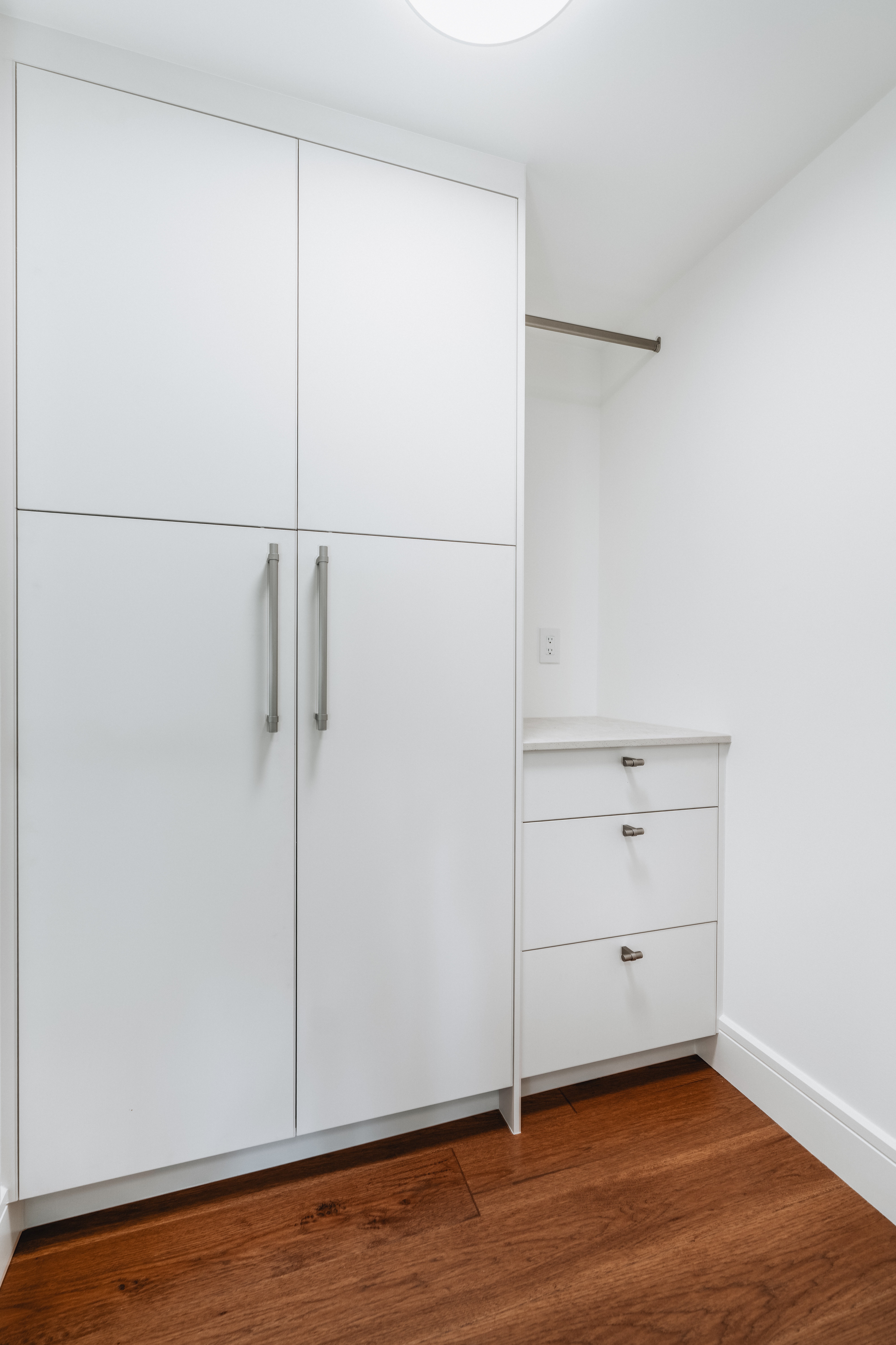 55-00-Minimalist floor-to-ceiling white storage cabinetry and custom built-in drawers, Vancouver.
